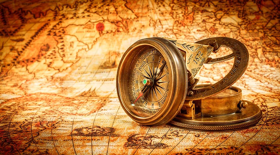 vintage compass on ancient map